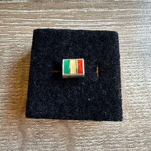 silver charm bead with green, yellow, and red enamel stripes